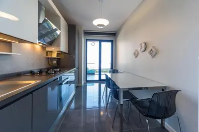 a kitchen with a table and chairs in it at Green Hills Suites in Yalova