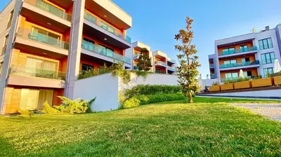 a building with a green lawn in front of it at Green Hills Suites in Yalova