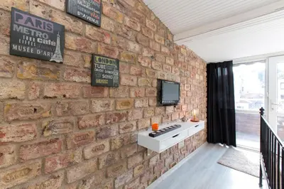 a brick wall with a stove and a tv on it at Antique Boutique in Istanbul