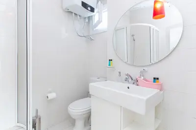 a white bathroom with a sink and a mirror at Antique Boutique in Istanbul