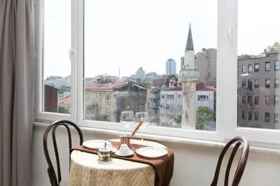 a table and chairs in a room with a window at Antique Boutique in Istanbul