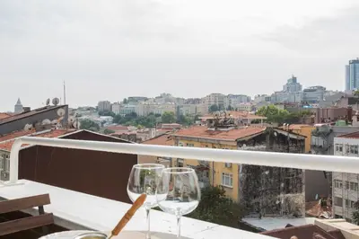 two wine glasses sitting on top of a balcony at Antique Boutique in Istanbul