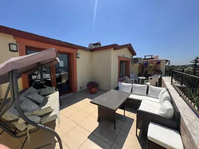 a patio with a couch and a table on a balcony at Doğa Villa Guest House in Buyukcekmece