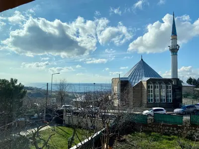 a church with a steeple and a building with a tower at Doğa Villa Guest House in Buyukcekmece