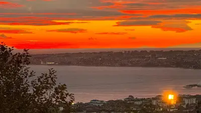 a sunset over a city and a body of water at Doğa Villa Guest House in Buyukcekmece