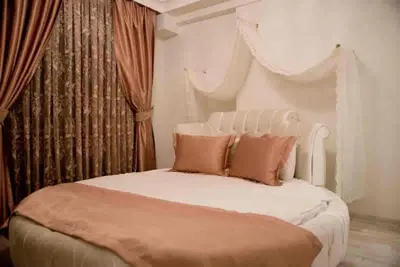 a bedroom with a white bed with two pillows at Nupelda Residence Hotel in Istanbul