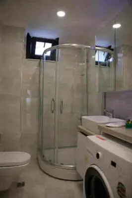a bathroom with a shower and a toilet and a sink at Nupelda Residence Hotel in Istanbul