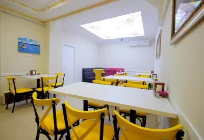 a dining room with yellow chairs and tables at Grand FM Hotel in Istanbul