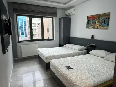 a bedroom with two beds and a window at Grand FM Hotel in Istanbul