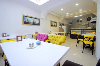 a dining room with tables and yellow chairs at Grand FM Hotel in Istanbul