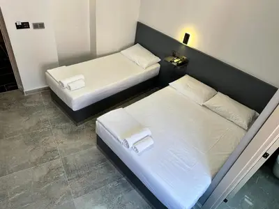 two beds in a small room with two bedsvisor at Grand FM Hotel in Istanbul
