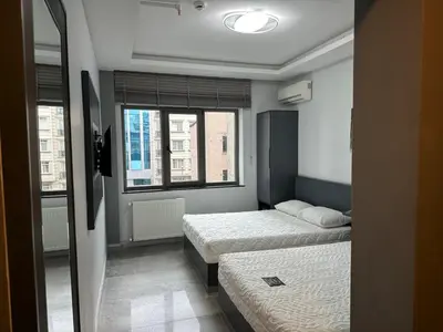 a bedroom with two beds and a window at Grand FM Hotel in Istanbul