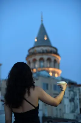 a woman holding a frisbee in front of a building at Meroddi La Porta in Istanbul