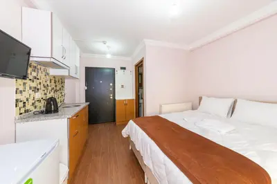 a small bedroom with a bed and a kitchen at Tavra hotel in Istanbul