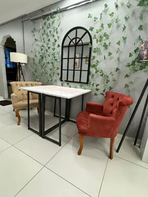 a living room with a table and a chair at Tavra hotel in Istanbul