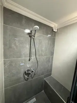 a shower with a shower head in a bathroom at Tavra hotel in Istanbul