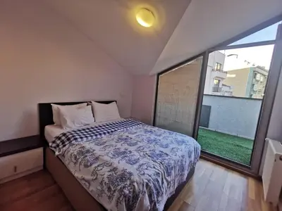 a bedroom with a bed and a large window at CTS Taksim Elysium Residence Dublex D-84 in Istanbul