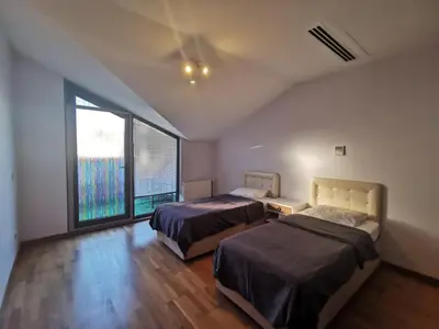 a bedroom with two beds and a large window at CTS Taksim Elysium Residence Dublex D-84 in Istanbul