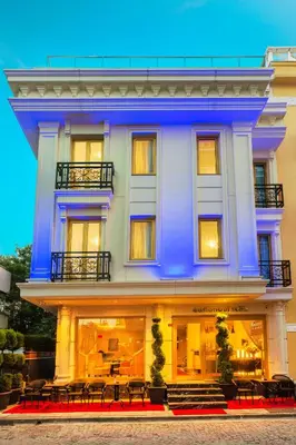 a large blue building with tables in front of it at Eastanbul Suites in Istanbul