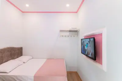 a bedroom with a bed and a tv on a wall at TAXİM ELEGANCE SUİTES in Istanbul