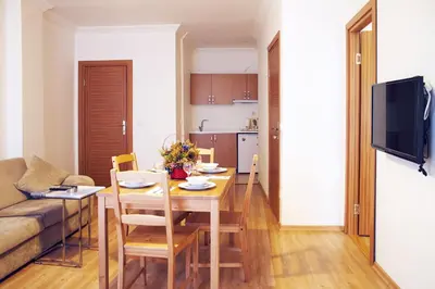 a living room and kitchen with a table and a couch at TAXİM ELEGANCE SUİTES in Istanbul