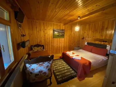 a bedroom with a bed and a chair in a room at Ağva Green River Hotel in Agva
