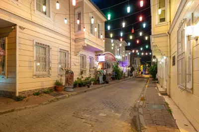 an empty street at night with lights and buildings at Enderun by Otantik Suites in Istanbul