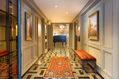 a hallway with a bench and a piano in a room at Güner Business Hotel in Istanbul