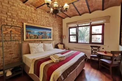 a bedroom with a large bed in a brick wall at Ottobalat in Istanbul