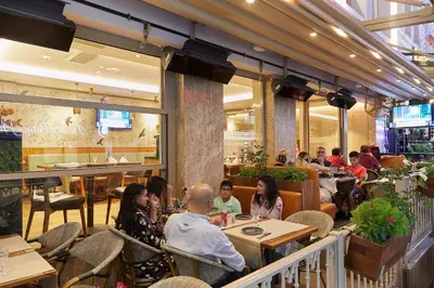 a group of people sitting at tables in a restaurant at Levni Plus Hotel in Istanbul