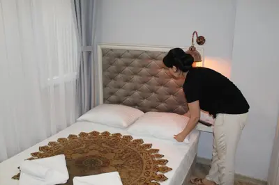 a woman is standing on a bed at Good Night Hotel Istanbul in Istanbul