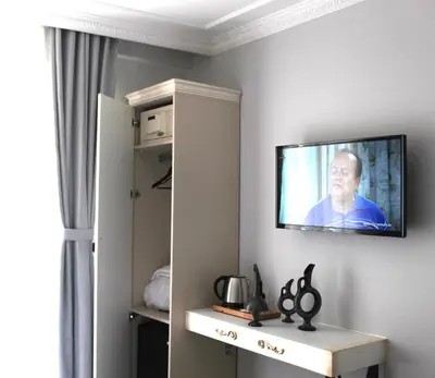 a television hanging on a wall in a room at Good Night Hotel Istanbul in Istanbul