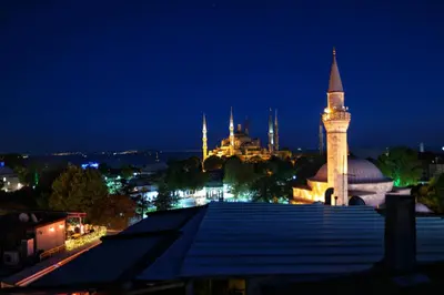 a view of a city at night with a mosque at Nomade Old City Hotel in Istanbul