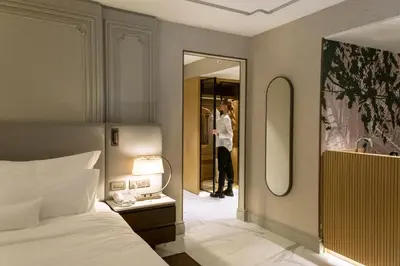a woman taking a picture in a mirror in a bedroom at Stayso The House Hotel in Istanbul