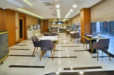 a dining room with tables and chairs in a restaurant at The Tango Hotel Taksim in Istanbul