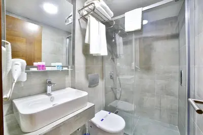 a bathroom with a sink and a toilet and a shower at The Tango Hotel Taksim in Istanbul