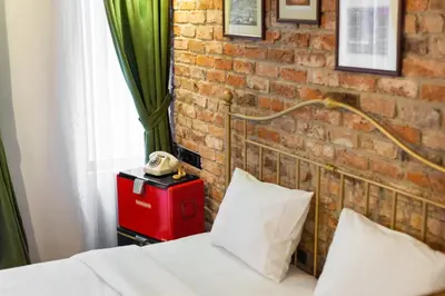a bedroom with a brick wall and a bed at Hotel Des Arts Galata in Istanbul