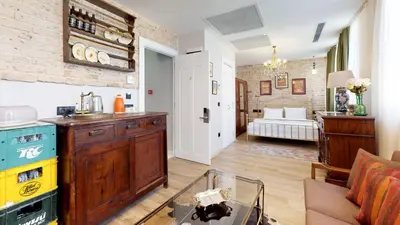 a living room with a kitchen and a living room with a couch at Hotel Des Arts Galata in Istanbul