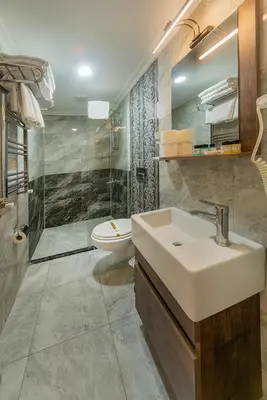 a bathroom with a sink and a toilet at Beyazit Palace Hotel in Istanbul