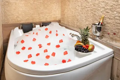 a bowl of fruit sitting on a toilet in a bathroom at İstanbul Hotel & Suites in Istanbul