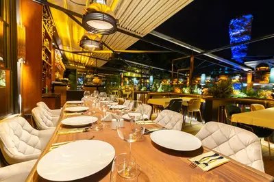 a dining room with a long table and white chairs at No2 Hotel By Şükrü in Adalar