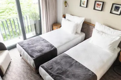 two beds in a hotel room with a window at MEG HOTEL in Istanbul