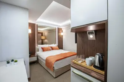 a hotel room with a bed and a kitchen at Sherry Suites Karaköy in Istanbul