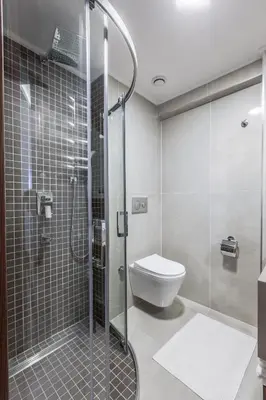 a bathroom with a toilet and a glass shower at Sherry Suites Karaköy in Istanbul