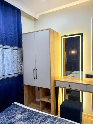a bedroom with a bed and a desk and a mirror at The Reina Hotel in Istanbul