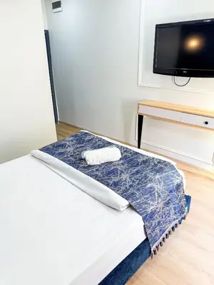 a room with a bed and a flat screen tv at The Reina Hotel in Istanbul
