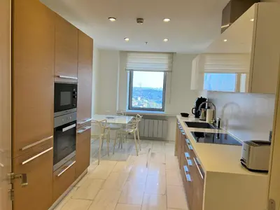 a kitchen with wooden cabinets and a table in it at Akmerkez Residence in Istanbul