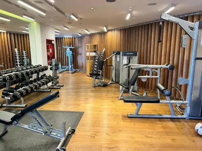 a gym with a row of treadmills and machines at Akmerkez Residence in Istanbul