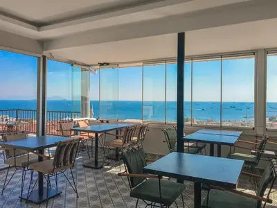 a restaurant with tables and chairs and windows at Sultanahmet Nu Hotel in Istanbul