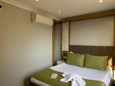 a bedroom with a bed with a towel on it at Sultanahmet Nu Hotel in Istanbul
